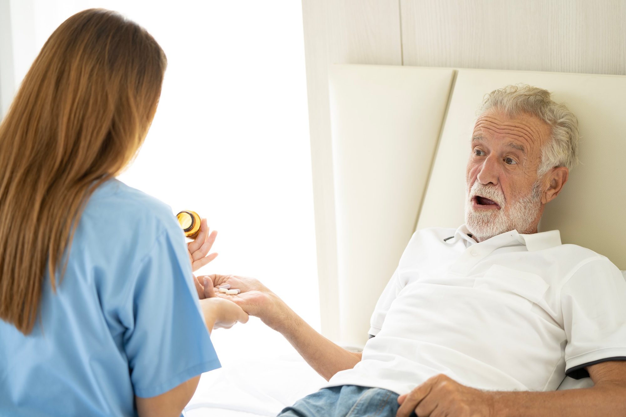 Man being cared for by a private Asian nurse at home